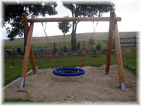 dump swing consisting out of larch wood with chair swing  Ø 120 cm